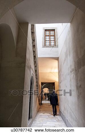 Stock Image - Man walking through a corridor of a harem at Topkapi Palace, Istanbul, Turkey. Fotosearch