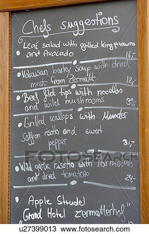 Stock Image - Menu board in a restaurant, Whymper-Stube, Zermatt, Valais Canton, Switzerland. Fotosearch