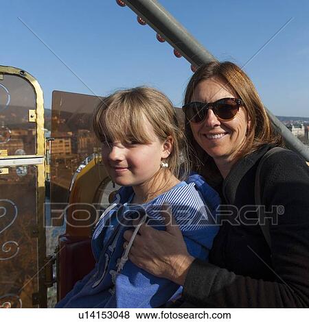 Stock Photo - Mother and daughter on a ferris wheel, Bahnhofstrasse, Zurich, Switzerland. Fotosearch