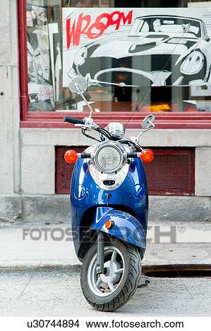 Motor scooter parked outside a store, Ville-Marie, Montreal, Quebec, Canada View Large Photo Image Picture - Motor scooter parked outside a store, Ville-Marie, Montreal, Quebec, Canada. Fotosearch