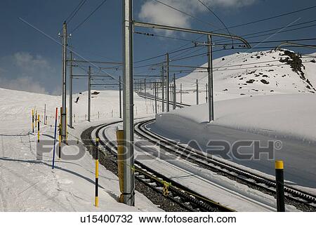 Railroad tracks at snowy valley in winter, Zermatt, Valais Canton, Switzerland View Large Photo Image Stock Image - Railroad tracks at snowy valley in winter, Zermatt, Valais Canton, Switzerland. Fotosearch
