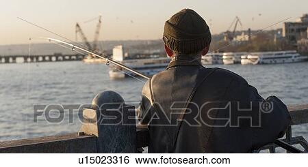Rear view of a man fishing in a river, Bosphorus River, Istanbul, Turkey View Large Photo Image Stock Photograph - Rear view of a man fishing in a river, Bosphorus River, Istanbul, Turkey. Fotosearch