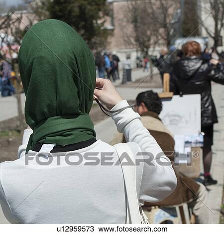 Stock Image - Rear view of a woman photographing with a camera, Aya Sofya, Istanbul, Turkey. Fotosearch