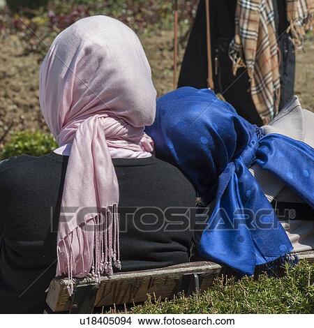 Picture - Rear view of two women resting on a bench, Sultanahmet, Istanbul, Turkey. Fotosearch