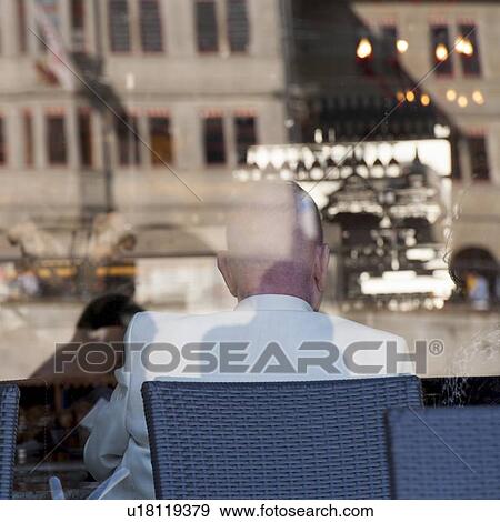 Stock Photo - Reflection of a man in a restaurant window, Bahnhofstrasse, Zurich, Switzerland. Fotosearch