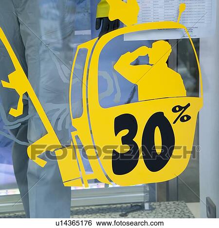 Stock Photograph - Sale discount percentage sign on the window of a store, Chamonix, Rhone-Alpes, France. Fotosearch