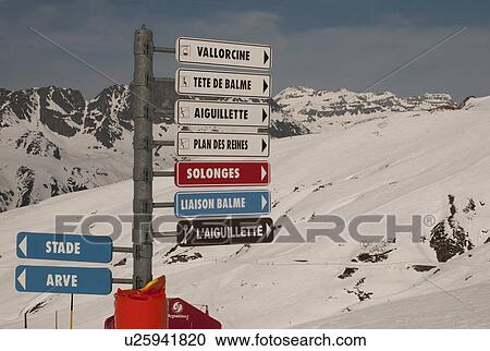 Stock Image - Signpost at snow covered ski area, Domaine De Balme, Vallorcine, Mont Blanc, Chamonix, Rhone-Alpes, France. Fotosearch