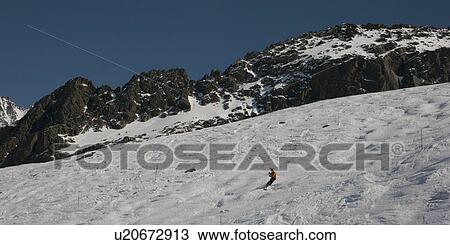 Stock Image - Skier in action at Les Grands Montets ski area, Mont Blanc, Chamonix, Rhone-Alpes, France. Fotosearch