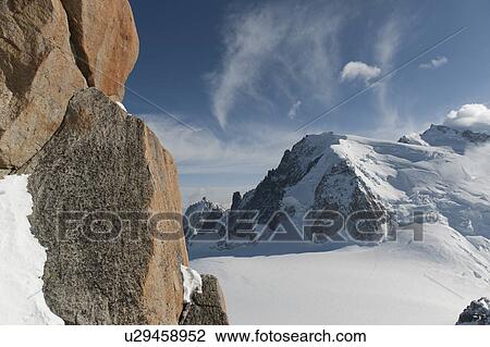 Stock Image - Snow covered mountains and rocks in winter, Aiguille Du Midi, Mont Blanc, Chamonix, Rhone-Alpes, France. Fotosearch