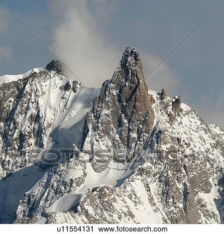 Stock Image - Snow covered mountains in winter, Aiguille Du Midi, Mont Blanc, Chamonix, Rhone-Alpes, France. Fotosearch