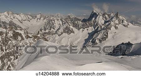 Stock Photo - Snow covered mountains in winter, Aiguille Du Midi, Mont Blanc, Chamonix, Rhone-Alpes, France. Fotosearch