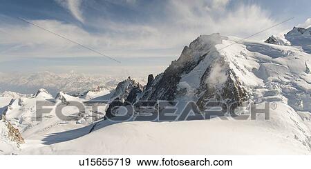 Stock Photo - Snow covered mountains in winter, Aiguille Du Midi, Mont Blanc, Chamonix, Rhone-Alpes, France. Fotosearch