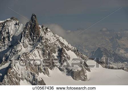Stock Photograph - Snow covered mountains in winter, Aiguille Du Midi, Mont Blanc, Chamonix, Rhone-Alpes, France. Fotosearch