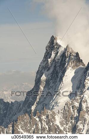 Stock Photography - Snow covered mountains in winter, Aiguille Du Midi, Mont Blanc, Chamonix, Rhone-Alpes, France. Fotosearch
