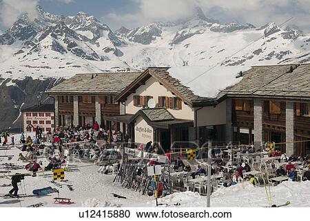Stock Image - Tourists at a ski resort, Zermatt, Valais Canton, Switzerland. Fotosearch