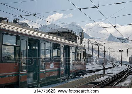 Train at station in the snowy valley, Zermatt, Valais Canton, Switzerland View Large Photo Image Stock Image - Train at station in the snowy valley, Zermatt, Valais Canton, Switzerland. Fotosearch