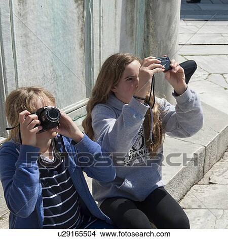 Two girls photographing with digital cameras, Blue Mosque, Istanbul, Turkey View Large Photo Image Picture - Two girls photographing with digital cameras, Blue Mosque, Istanbul, Turkey. Fotosearch