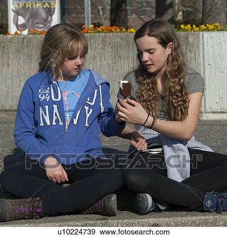 Two sisters sharing an ice cream, District 1, Zurich, Switzerland View Large Photo Image Stock Photo - Two sisters sharing an ice cream, District 1, Zurich, Switzerland. Fotosearch