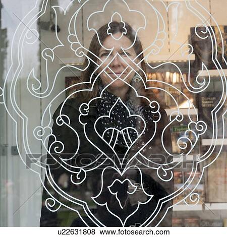 Stock Photo - Woman behind a painted glass in Topkapi Palace, Istanbul, Turkey. Fotosearch