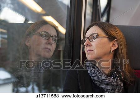 Stock Photo - Woman looking through a train window, Chamonix, Rhone-Alpes, France. Fotosearch