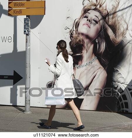 Woman walking on a street, District 1, Zurich, Switzerland View Large Photo Image Picture - Woman walking on a street, District 1, Zurich, Switzerland. Fotosearch