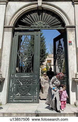 Stock Photograph - Woman with her daughter coming outside from a building, Istanbul, Turkey. Fotosearch