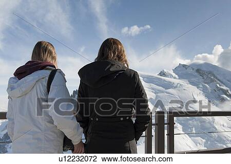 Woman with her daughter looking at snow covered mountains from an observation point, Aiguille Du Midi, Mont Blanc, Chamonix, Rhone-Alpes, France View Large Photo Image Stock Image - Woman with her daughter looking at snow covered mountains from an observation point, Aiguille Du Midi, Mont Blanc, Chamonix, Rhone-Alpes, France. Fotosearch