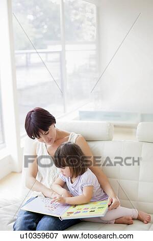 Stock Photo - Mother and daughter reading. Fotosearch