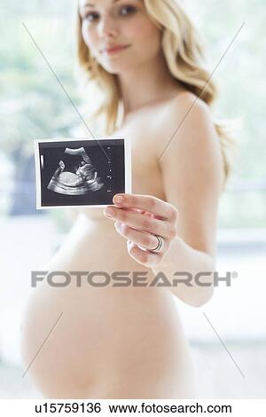 Stock Photograph - Pregnant woman and baby scan. Fotosearch