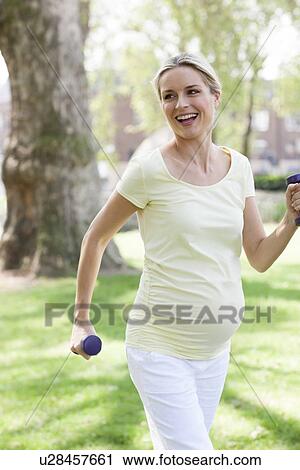 Pregnant woman exercising View Large Photo Image Stock Image - Pregnant woman exercising. Fotosearch