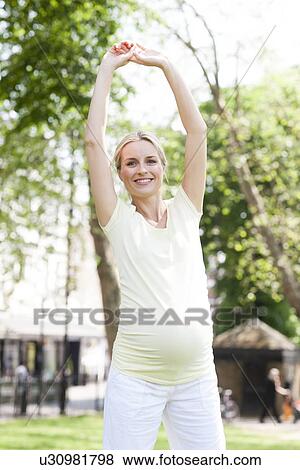 Pregnant woman stretching View Large Photo Image Stock Photo - Pregnant woman stretching. Fotosearch