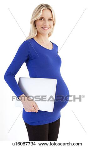 Picture - Pregnant woman with a laptop. Fotosearch