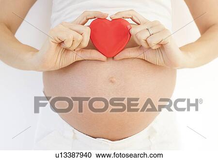 Stock Image - Pregnant woman's abdomen. Fotosearch