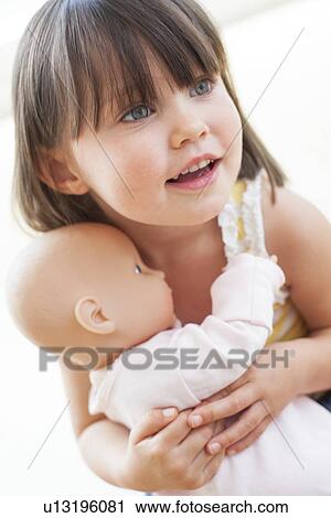Stock Image - Toddler and doll. Fotosearch