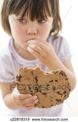Stock Photo - Toddler eating a cookie. Fotosearch