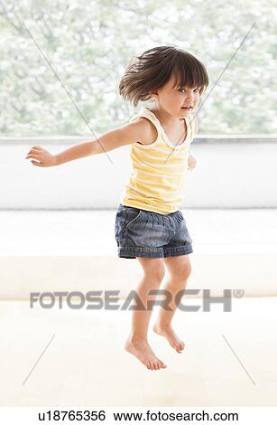 Stock Photograph - Toddler jumping. Fotosearch