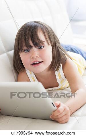 Picture - Toddler using a tablet computer. Fotosearch