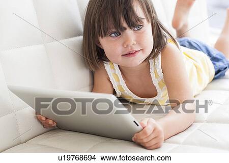 Toddler using a tablet computer View Large Photo Image Picture - Toddler using a tablet computer. Fotosearch