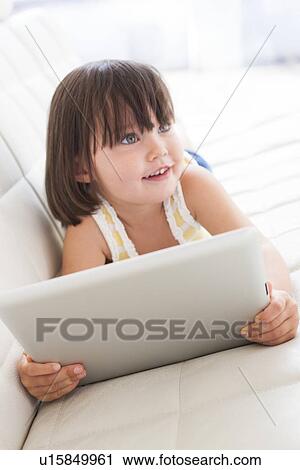 Stock Image - Toddler using a tablet computer. Fotosearch