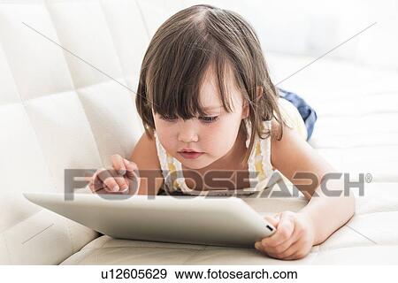 Toddler using a tablet computer View Large Photo Image Stock Photo - Toddler using a tablet computer. Fotosearch
