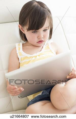 Stock Photo - Toddler using a tablet computer. Fotosearch