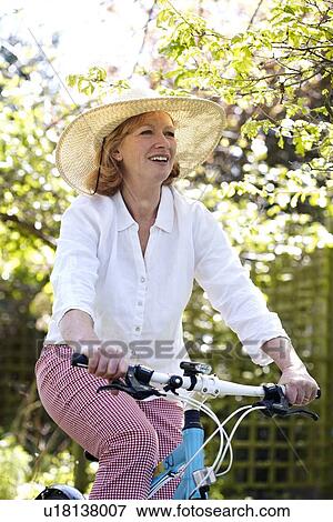Woman cycling View Large Photo Image Stock Photo - Woman cycling. Fotosearch