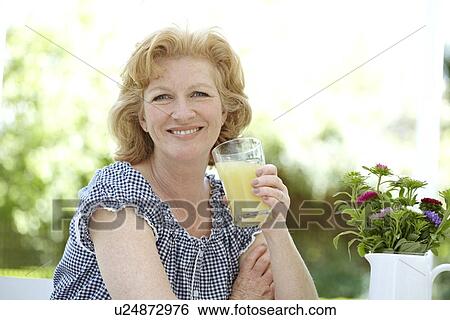 Stock Photograph - Woman drinking fruit juice. Fotosearch