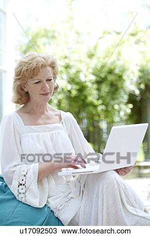 Woman using a laptop View Large Photo Image Stock Image - Woman using a laptop. Fotosearch