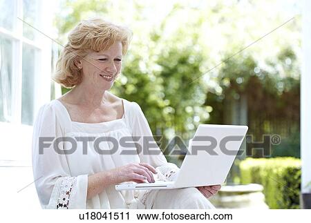 Woman using a laptop View Large Photo Image Stock Image - Woman using a laptop. Fotosearch