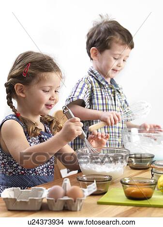 Young children baking View Large Photo Image Picture - Young children baking. Fotosearch