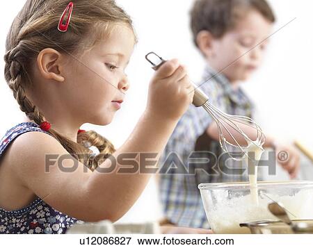 Young children baking View Large Photo Image Stock Photo - Young children baking. Fotosearch