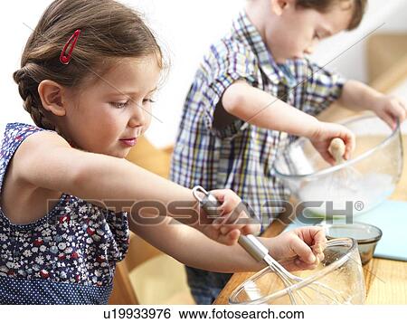 Young children baking View Large Photo Image Stock Photograph - Young children baking. Fotosearch