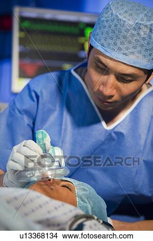 Administering anaesthetic View Large Photo Image Picture - Administering anaesthetic. Fotosearch