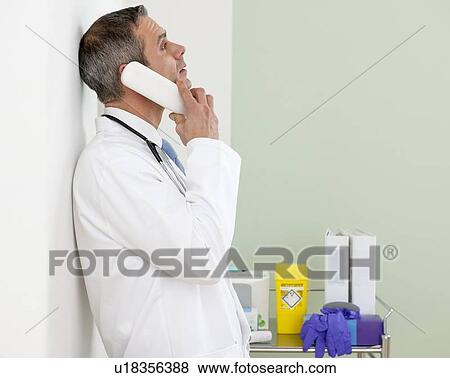 Stock Photo - Doctor using a phone. Fotosearch